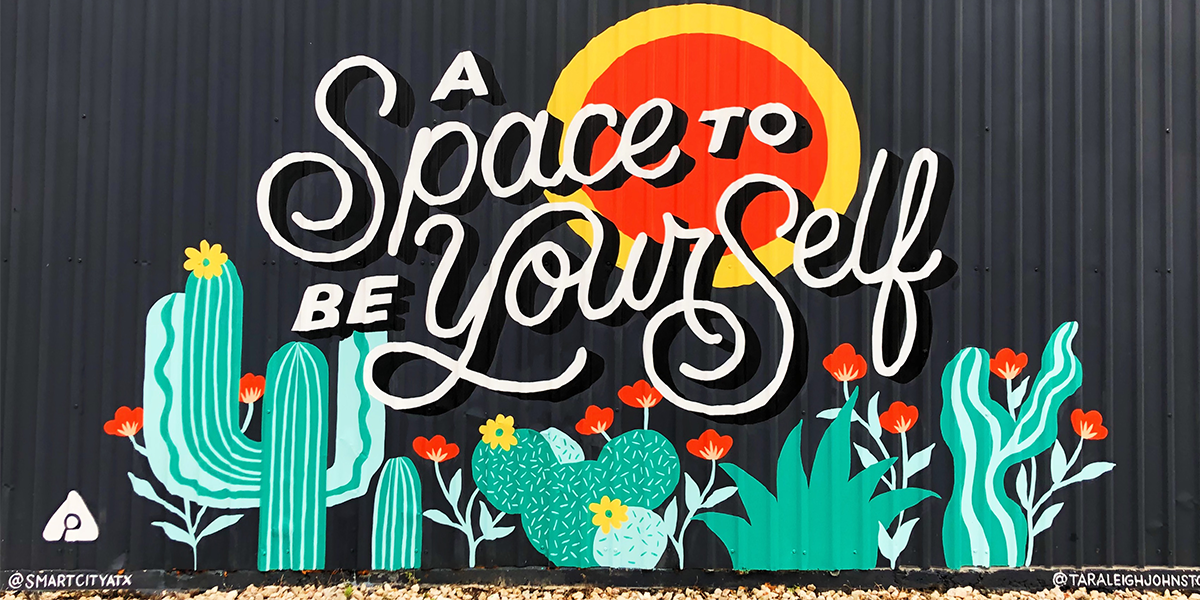 "a space to be yourself" mural with sun and cacti