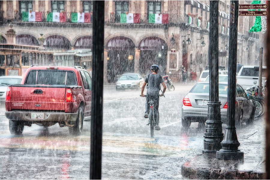 Man Riding Bike in Rain